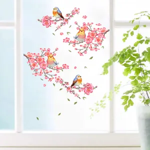 Pegatinas de pared de pájaros y flores de cerezo en una ventana blanca brillante