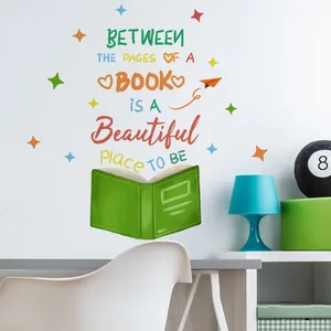 Wall decal with motivational quote Between the pages of a book on a clean white library wall