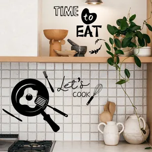 Detail of matte black vinyl wall stickers featuring kitchen utensils and quote for dining room