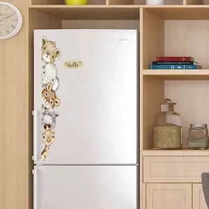 Detail of Hello animal wall stickers featuring a lion, elephant and giraffe on a white fridge