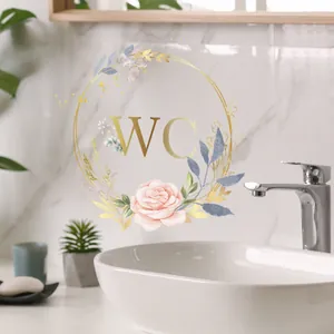 Detail of floral WC wall sticker with gold wreath and pink roses on marble tile