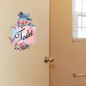Detail of floral bathroom wall sticker with blue bird and Toilet text in hexagonal frame