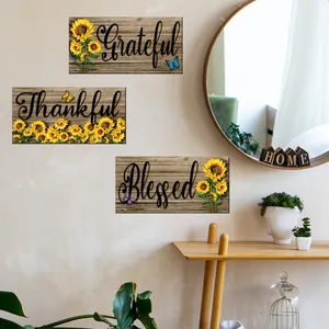 Detail view of sunflower wooden wall plaques with Grateful and Blessed text in home setting