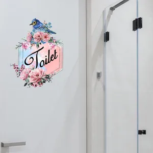 Detail of toilet wall decal with blue bird, pink flowers and artistic Toilet lettering
