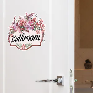Floral bathroom door sticker featuring pink flowers and Bathroom text on white door