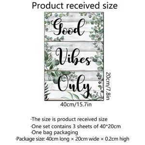 Three-piece eucalyptus leaf wall decals with Good Vibes Only text on white wood grain