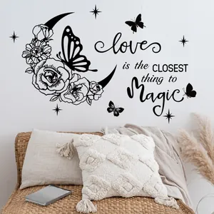 Detail view of floral moon and butterfly wall stickers in a cozy boho bedroom setting