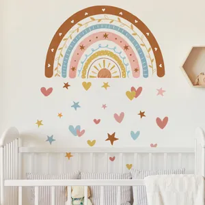Detail of boho rainbow wall stickers with stars and hearts in soft Morandi tones for nursery