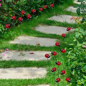 Garden path view featuring multiple red ladybug decorative lawn stakes along stone steps
