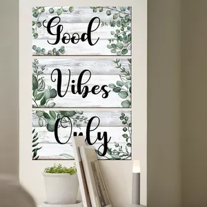 Modern wall art showing Good Vibes Only typography with eucalyptus leaves in a cozy room