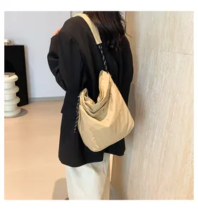 Detail of khaki nylon hobo bag showing large capacity and soft drape on shoulder
