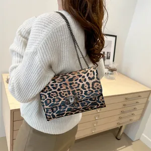 Stylish leopard print crossbody bag with metal chain strap and V-shaped clasp detail
