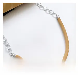 Detail of camel leather shoulder strap with silver metal chain and comfortable shoulder pad