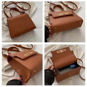 Vue détaillée du sac à main marron en cuir avec boucles dorées et intérieur spacieux