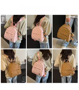 Detailed view of mini backpack with cute bunny patterns and plush pendant charms