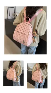 Pink backpack featuring all-over rabbit print and a cute plush animal charm accessory