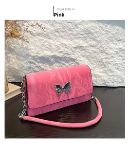 Detailed view of pink bow baguette bag with liquid metal buckle and silver chain strap