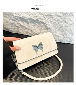 Top view of white textured PU leather handbag with silver metallic butterfly clasp