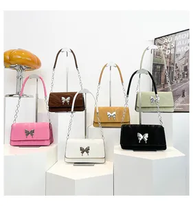 Detailed display of square shoulder bags in various colors featuring silver butterfly buckles