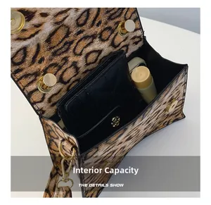 Internal capacity detail showing leopard print bag with wallet and cosmetics