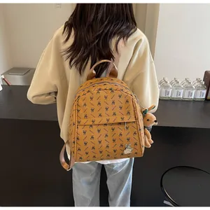 Brown PU leather backpack with black letter patterns and a cute silver bunny emblem