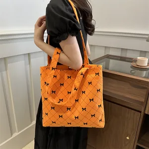 Sac cabas en velours côtelé orange avec motif losanges noirs et petits nœuds