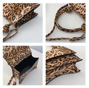 Detail view of leopard print texture, gold magnetic closure and adjustable shoulder strap