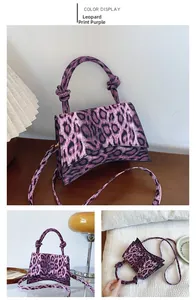 Detail view of purple leopard print textured PU bag with signature curved bottom and knot handle