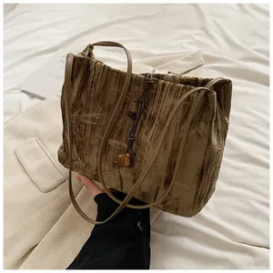 Detail of bamboo-leaf texture tote bag with rope weave and marble pendant