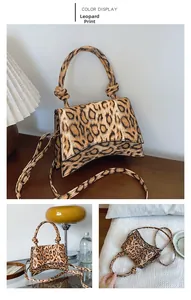 Detail of leopard print yellow crossbody bag with knot handle and curved base