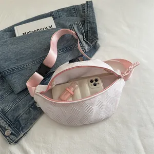 White striped waist bag with pink strap showing spacious interior with phone and cosmetic