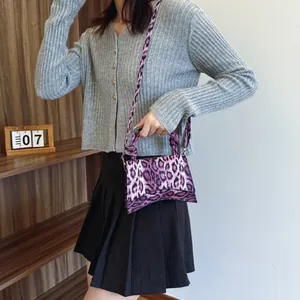 Fashionable purple leopard print hourglass handbag with adjustable crossbody strap