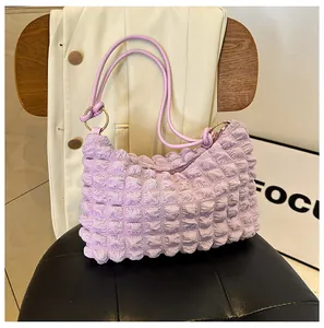Detail of light purple bubble textured tote bag showing 3D popcorn pleated fabric and zipper