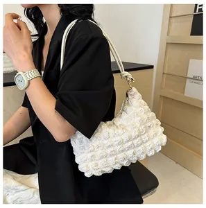 Detail showing white bubble texture and soft cloud-like pleats on the elegant shoulder bag