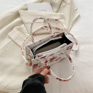 White butterfly print square handbag with red patterns and internal zipper compartment