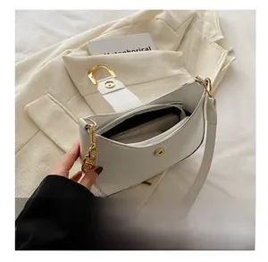 Interior view showing the storage capacity of the white crescent underarm bag