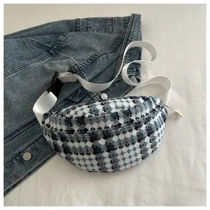 Detailed view of the blue and white tweed texture on a crescent fanny pack for women