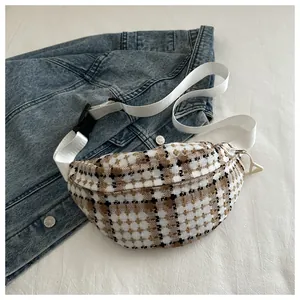 Detail of tweed checkered fanny pack with white woven strap and plastic buckle closure