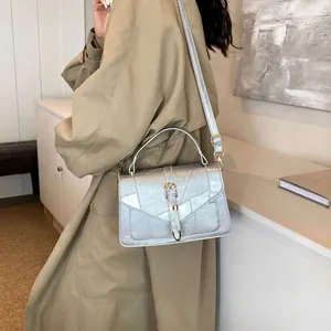 Silver metallic crossbody bag with gold horsebit hardware and geometric texture
