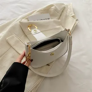 White minimalist croissant shoulder bag with crocodile texture and gold metal chain