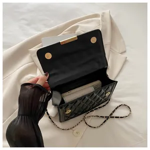 Internal view of black quilted crossbody bag showing space for phone and small wallet