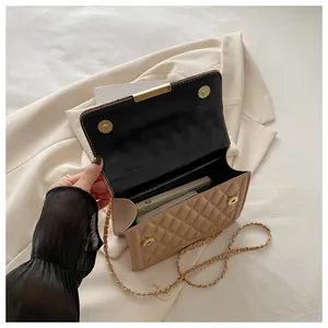 Inside view of beige quilted crossbody bag with golden chain and spacious interior compartment