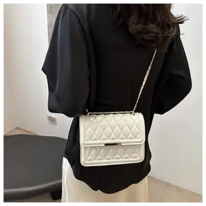 Detailed back view of a white quilted shoulder bag with golden chain and metal trim