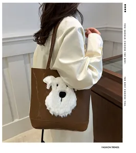 Close-up of brown PU tote bag featuring a cute white plush puppy embroidery detail