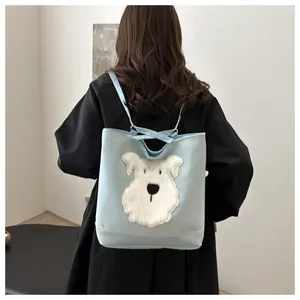 Detail showing plush schnauzer patch on light blue dual-use tote and backpack