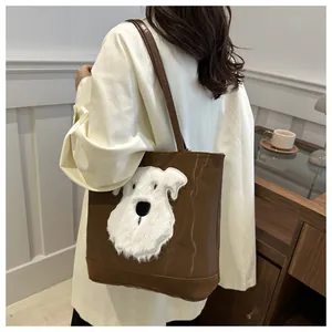 Detail of coffee brown tote bag with white plush dog patch in a cozy interior scene