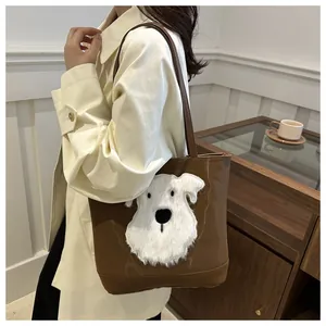 Detail of a brown leather tote bag with a white plush schnauzer dog patch on a model