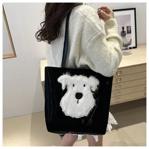 Detail of model wearing a black tote bag with a white plush puppy patch on the side