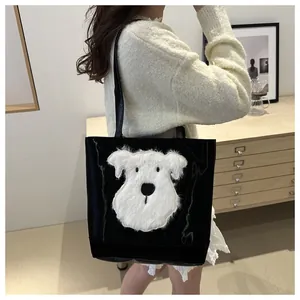 Detail of black tote bag with white plush dog design on soft corduroy material