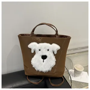 Close-up of a brown tote bag featuring a 3D plush puppy patch with soft fluffy texture